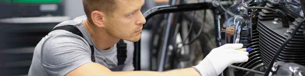 Person maintaining acetal motorcycle parts