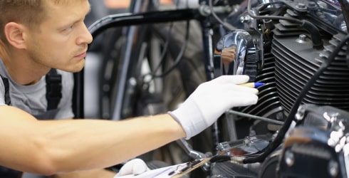 Person maintaining acetal motorcycle parts