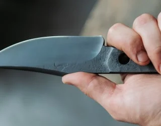 Smith holding a freshly forged knife
