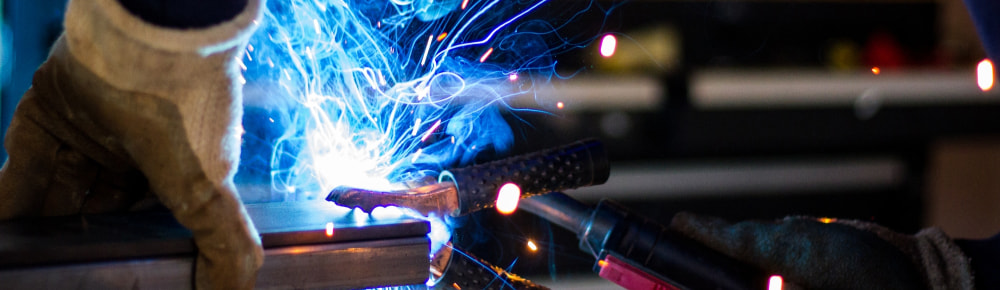 Blacksmith welding two pieces of metal