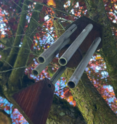 Some home made wind chimes hanging in a tree