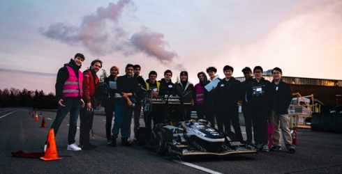 FSAE team standing around their car