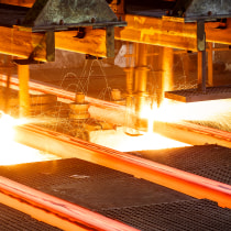 Iron bars being forged in a machine