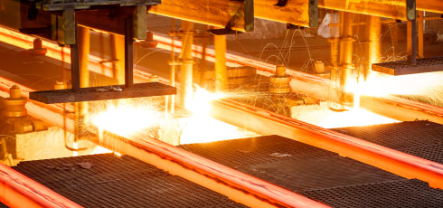 Iron bars being forged in a machine