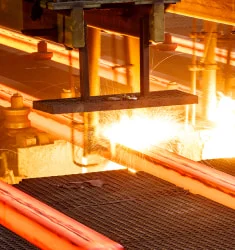 Pieces of steel being hot rolled in a mill