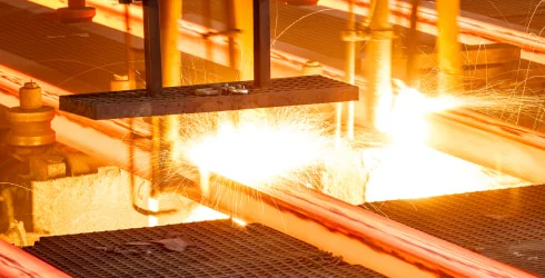 Hot steel being pressed in a mill