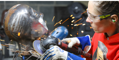Barbie Shaving some fine details into a metal bust