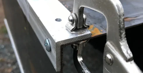 Weathered steel and aluminum angle corners clamped together