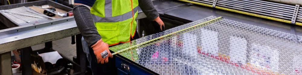 Online Metals employee custom cutting a sheet of metal