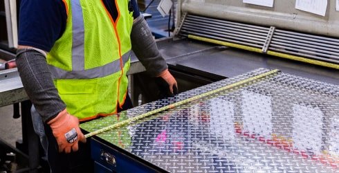 Online Metals employee custom cutting a sheet of metal