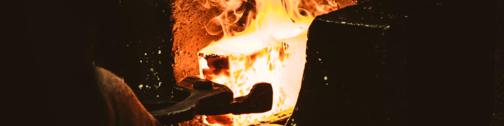 Piece of red hot glowing metal in forge