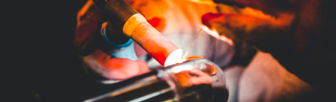 Welder welding a stainless steel tube