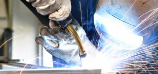 Welder welding a piece of steel