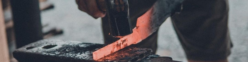 Blacksmith hammering a piece of steel