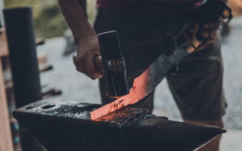 Blacksmith hammering a piece of steel