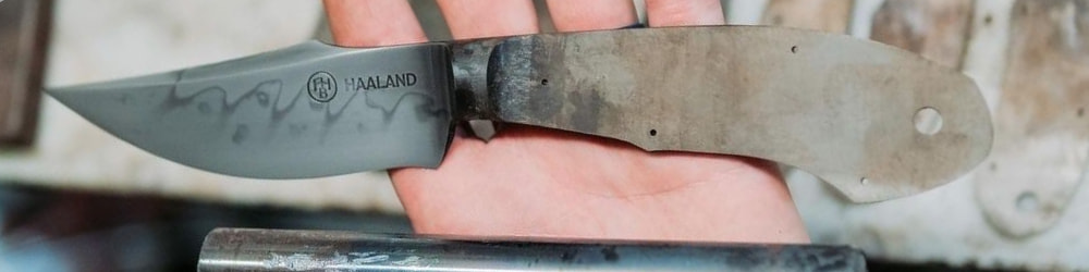 freshly made Curt Haaland knife in the palm of curts hand